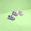 Three pairs of children's sports shoes are available in grey, purple and pink details Picture